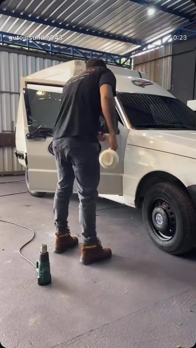 Guto aplicando película com soprador térmico no estúdio